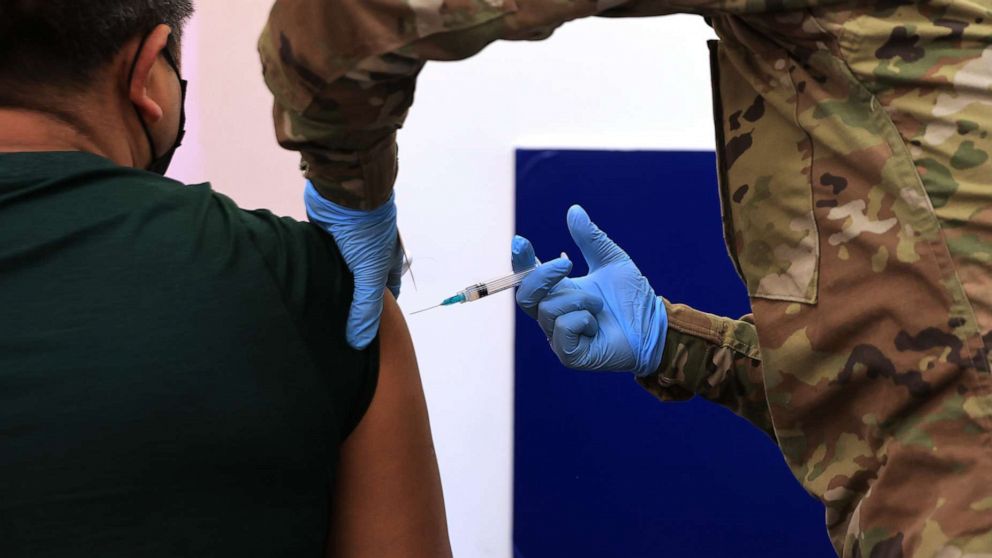 PHOTO: A member of the Maryland National Guard administers a Moderna coronavirus vaccine at CASA de Maryland's Wheaton Welcome Center on May 21, 2021, in Wheaton, Md.