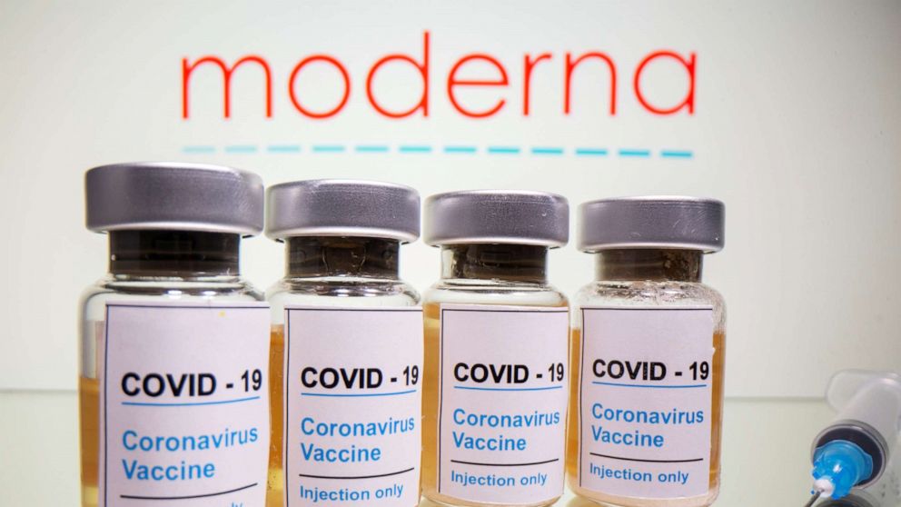 PHOTO: Vials with a sticker reading "COVID-19/Coronavirus vaccine/Injection only" and a syringe are seen in front of a displayed Moderna logo in this illustration taken October 31, 2020. 