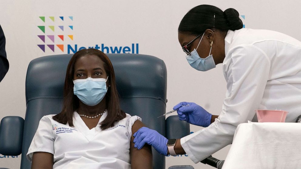 PHOTO: Sandra Lindsay, left, a nurse at Long Island Jewish Medical Center, is inoculated with the Pfizer-BioNTech COVID-19 vaccine by Dr. Michelle Chester, Dec. 14, 2020, in New York.