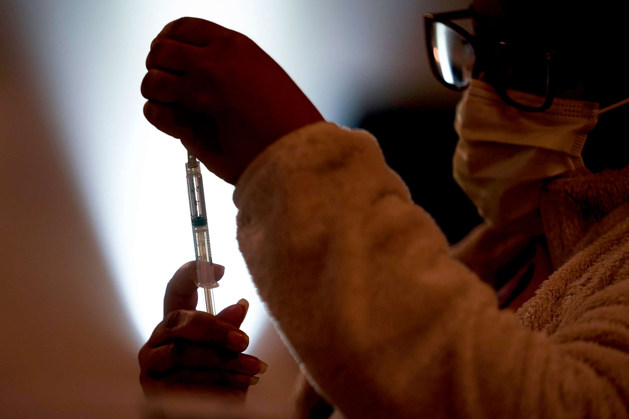 PHOTO: A health worker prepares a dose of the Pfizer COVID-19 vaccine during a vaccination clinic at the Grand Yesha Ballroom in Philadelphia, March 17, 2021. 