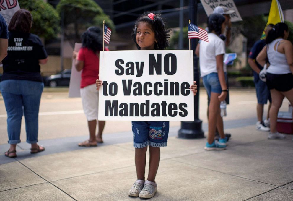 PHOTO: Anti-vaccine rally protesters hold signs outside of Houston Methodist Hospital in Houston, Texas, June 26, 2021.