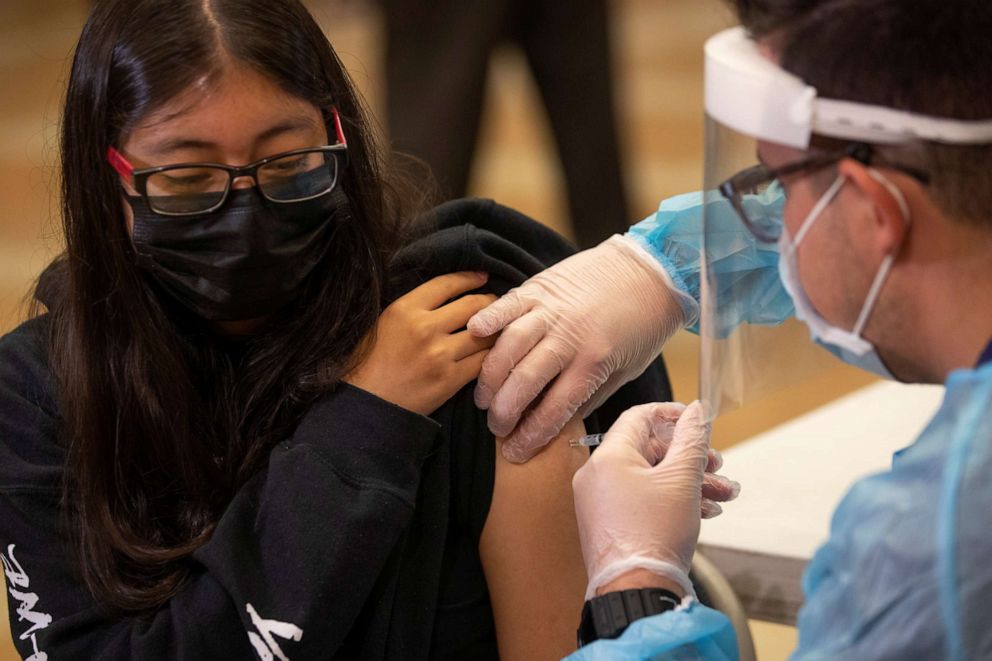 PHOTO: A student at Woodrow Wilson Senior High School receives a coronavirus vaccine from registered nurse Louis Chavez as students return to in-person classes in Los Angeles, Aug. 30, 2021.