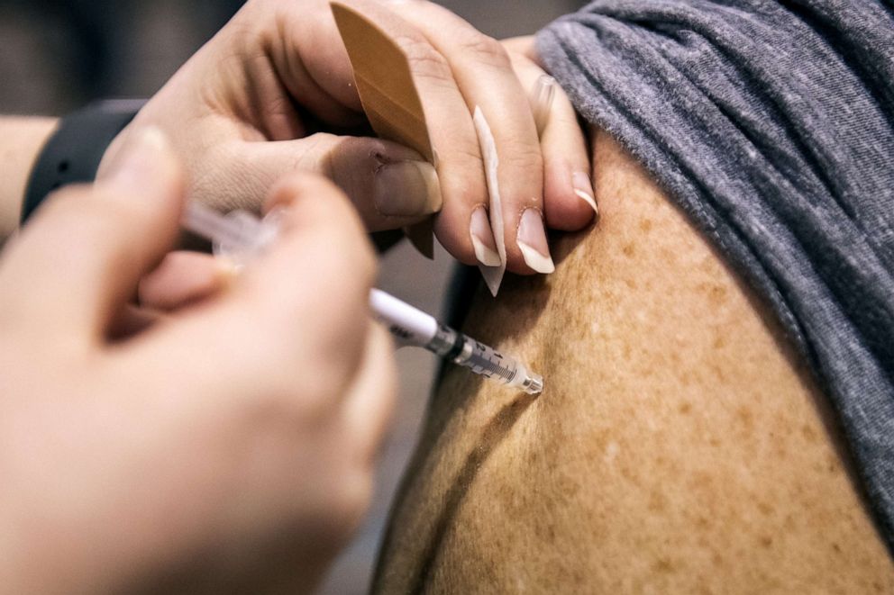 PHOTO: A healthcare worker administers a dose of the Pfizer-BioNTech Covid-19 vaccine at the Atlantic County vaccination megasite in Atlantic City, New Jersey, April 8, 2021. 