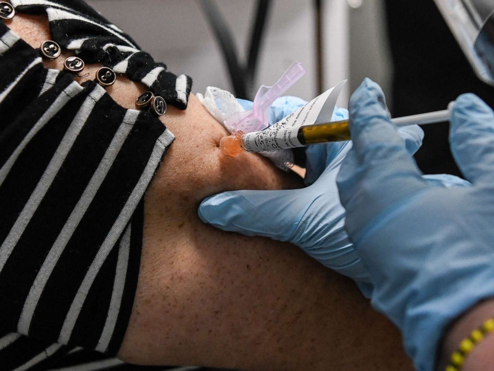 PHOTO: In this file photo taken on Aug. 13, 2020, Sandra Rodriguez, 63, receives a COVID-19 vaccination test from Yaquelin De La Cruz at the Research Centers of America in Hollywood, Fla.