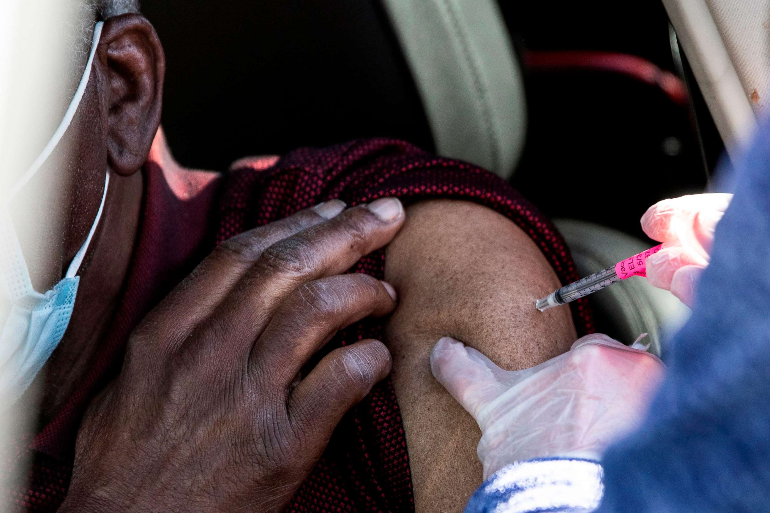 PHOTO: A man gets his first dose of the COVID-19 vaccine administered during mass vaccinations at Coors Field baseball stadium on Jan. 30, 2021, in Denver.