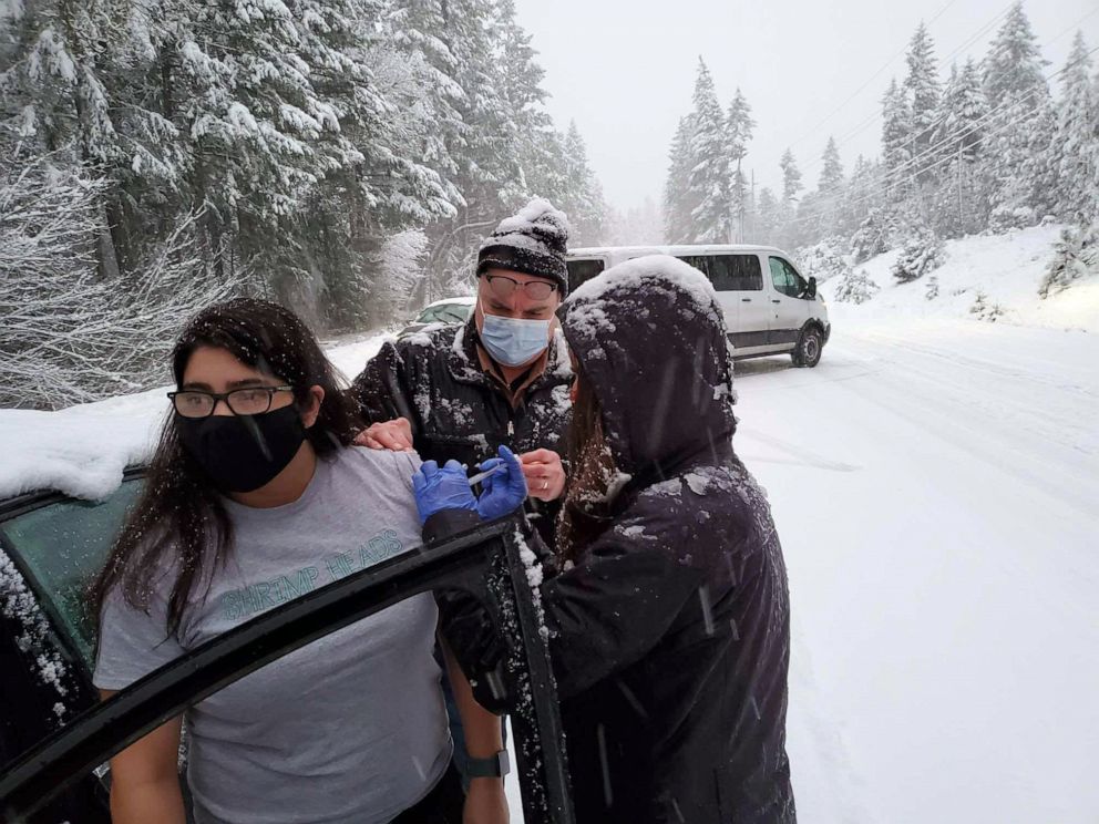 PHOTO: Public health workers in Josephine County, Ore., provide COVID-19 vaccination shots to motorists stranded during a snow storm on Jan. 26, 2021.
