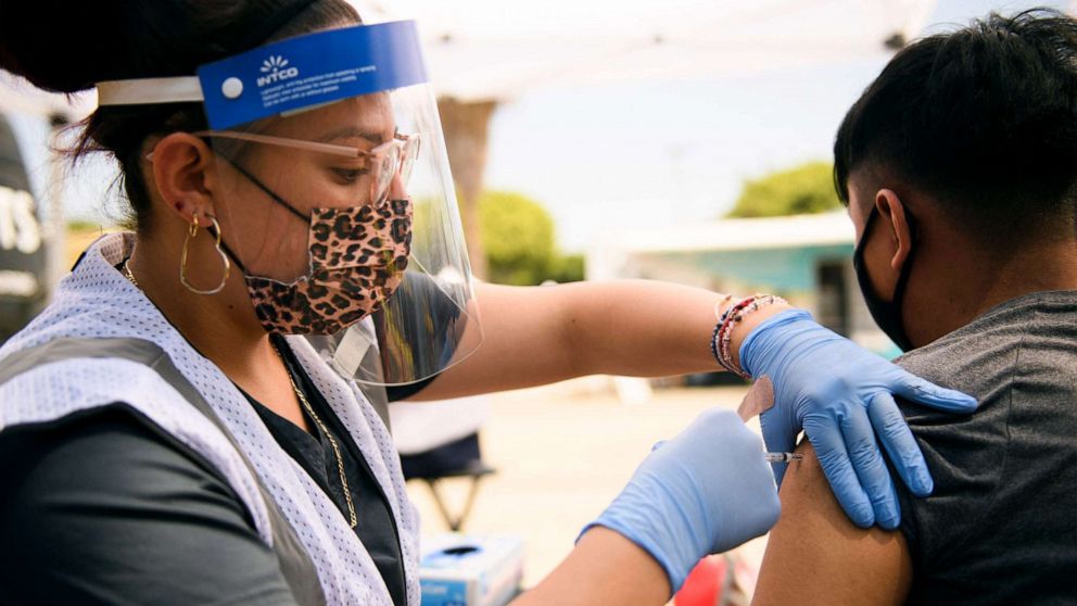 PHOTO: A 17-year-old receives a first dose of the Pfizer Covid-19 vaccine at a mobile vaccination clinic during a back to school event for children and their families at the Weingart East Los Angeles YMCA in Los Angeles, Aug. 7, 2021.