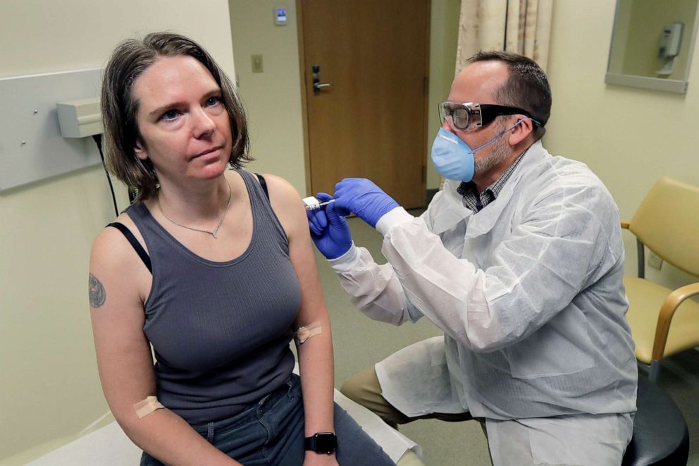 PHOTO: A pharmacist gives Jennifer Haller the first shot, March 16, 2020, in the first-stage safety study clinical trial of a potential vaccine for COVID-19, at the Kaiser Permanente Washington Health Research Institute in Seattle.