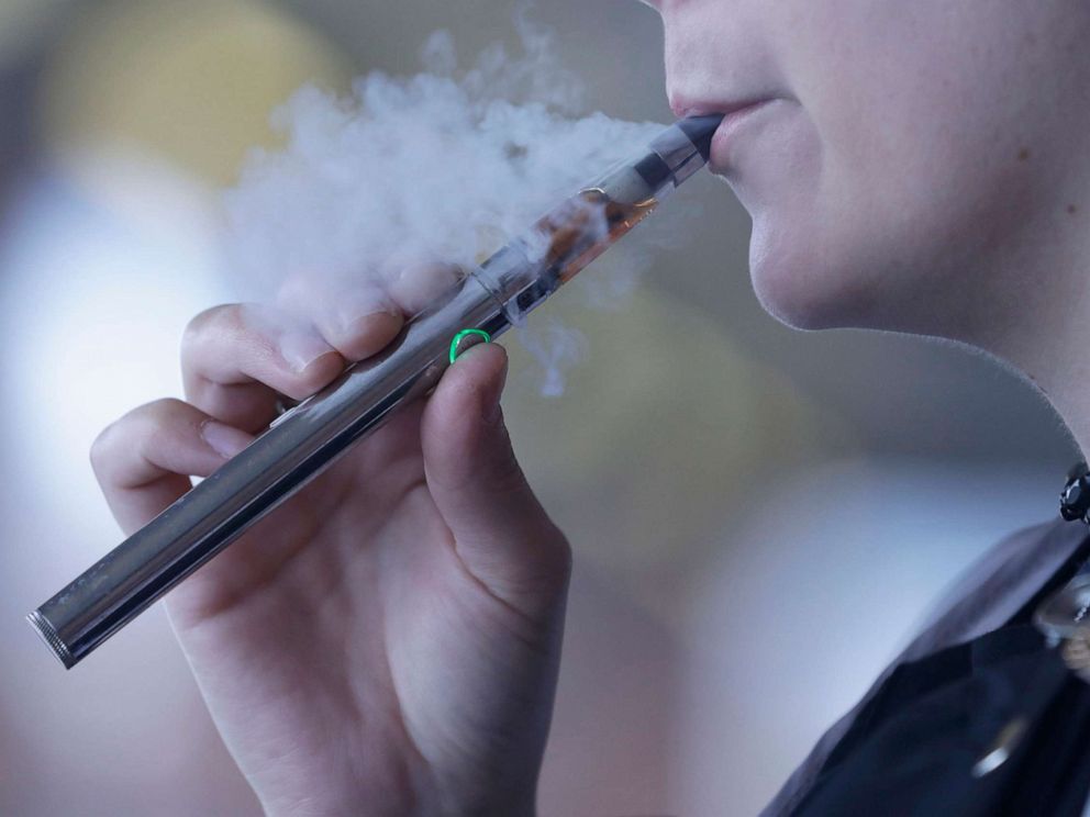 PHOTO: In this Oct. 4, 2019, photo, a woman using an electronic cigarette exhales in Mayfield Heights, Ohio.