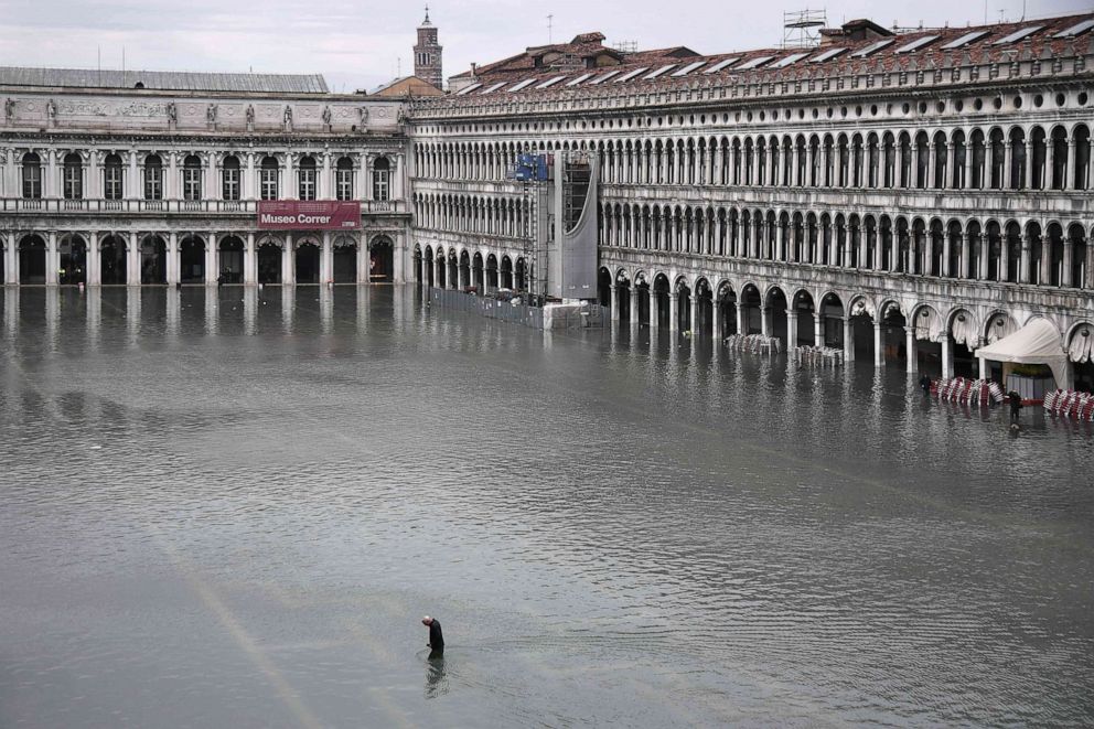 PHOTO: A general view shows a man crossing the flooded St. Mark's Square after an exceptional overnight "Alta Acqua" high tide water level, Nov. 13, 2019, in Venice.
