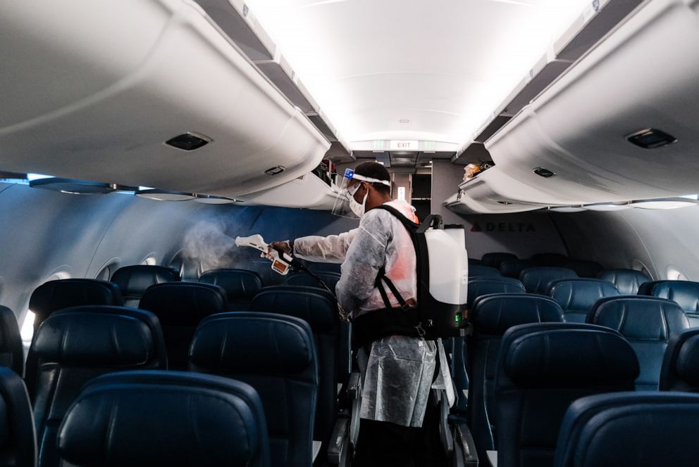 PHOTO: In this July 22, 2020, file photo, an airport employee performs an aircraft disinfecting demonstration during a media preview at the Ronald Reagan National Airport in Arlington, Va.