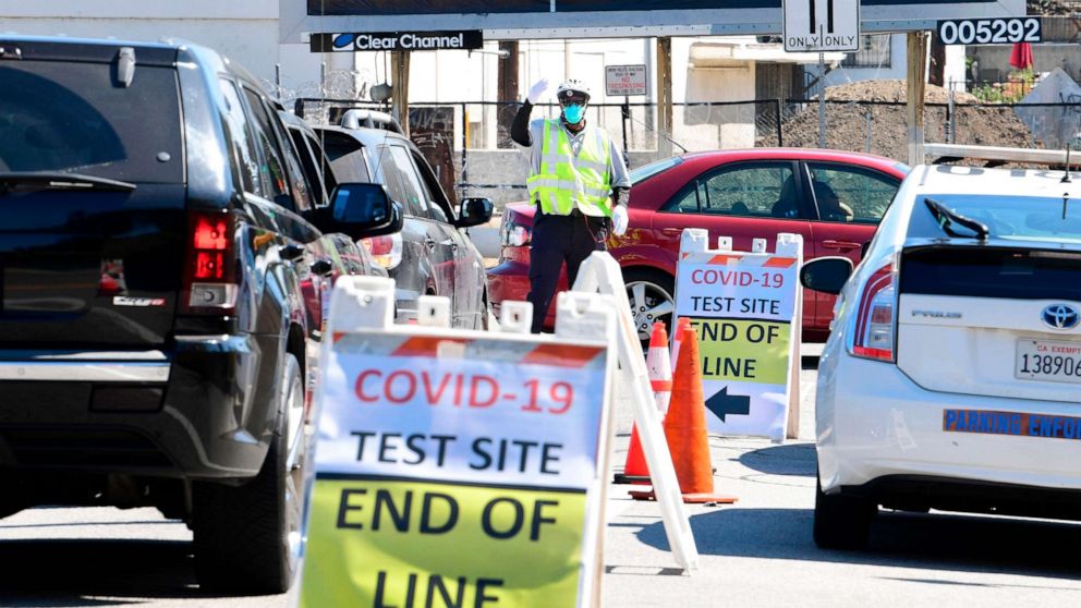 PHOTO: A traffic officer directs vehicles at a COVID-19 test site in Los Angeles, California on July 21, 2020. tty Images)