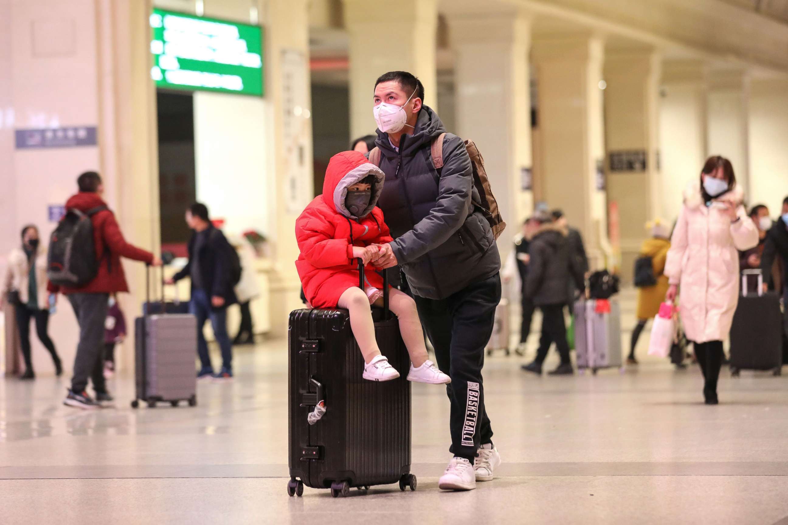 PHOTO: Commuters wearing face masks walk in a railway station in Wuhan, in China's central Hubei province, Jan. 21, 2020. Countries in Asia have ramped up measures to block the spread of a new virus as the death toll in China rose to six.