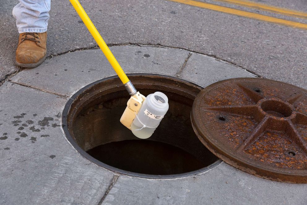 PHOTO: An employee collects a wastewater sample to monitor COVID-19 in Tucson, Ariz., Aug. 31, 2020.