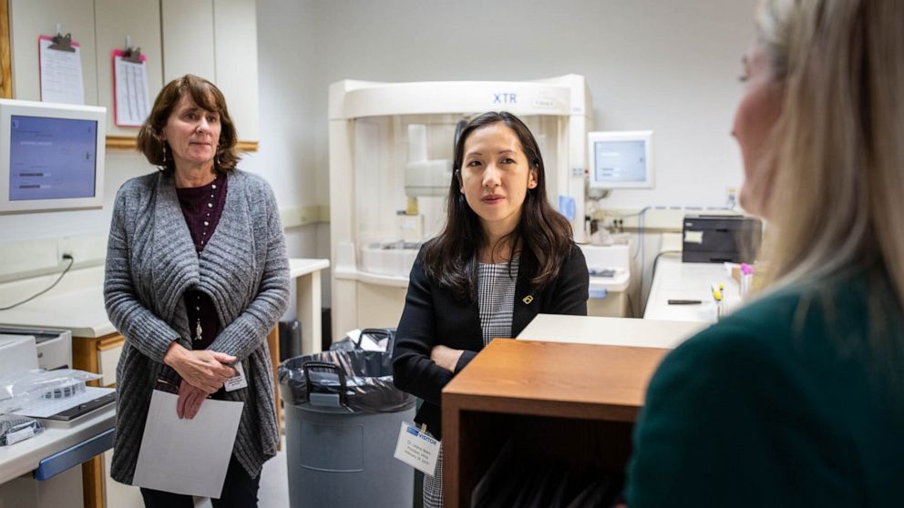 PHOTO: Dr. Leana Wen, president of Planned Parenthood, speaks with staff of Planned Parenthood Mar Monte in a basement lab that runs tests for gonorrhea and chlamydia. 