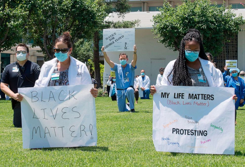 PHOTO: Doctors, nurses and other health care workers participate in a "White Coats for Black Lives" protest in solidarity with George Floyd and other black Americans killed by police officers, in West Covina, California, June 11, 2020.