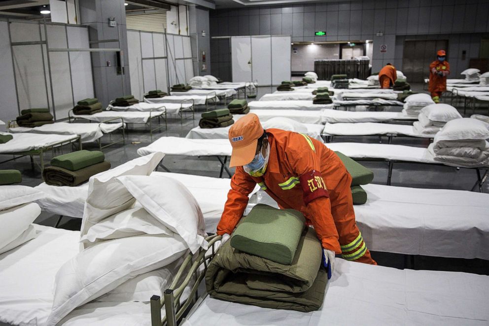 PHOTO: A cleaner checks beds at Wuhan International Conference and Exhibition Center, Feb. 4, 2020, in Wuhan, China.