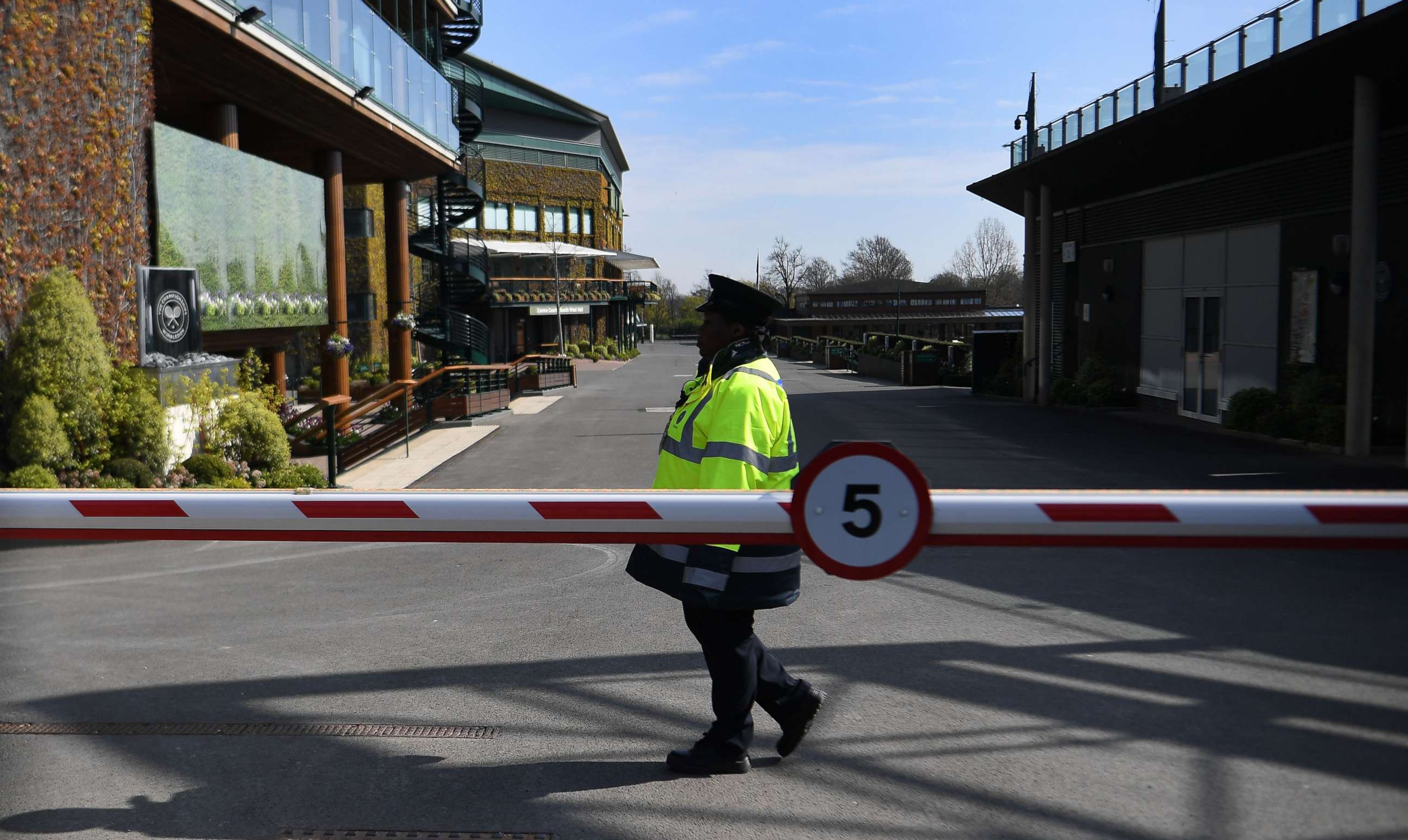 PHOTO: A security guard patrols at the All England Lawn Tennis Club in Wimbledon, London, April 1, 2020.