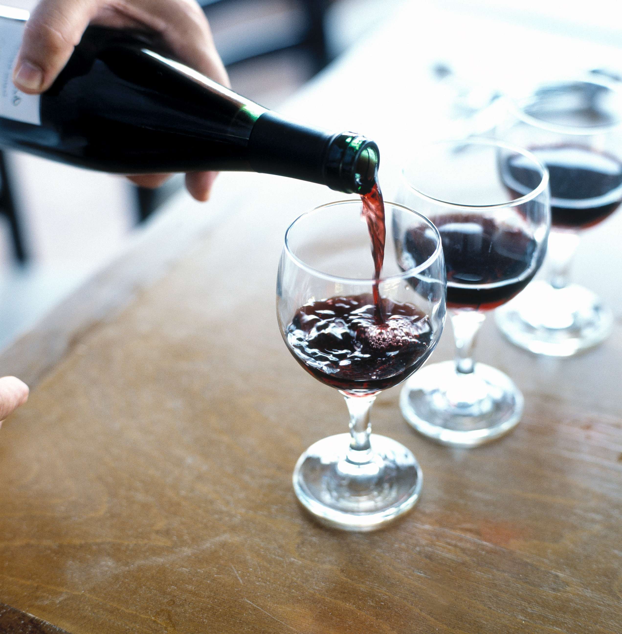 PHOTO: A person is pictured pouring red wine.