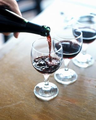 PHOTO: A person is pictured pouring red wine.