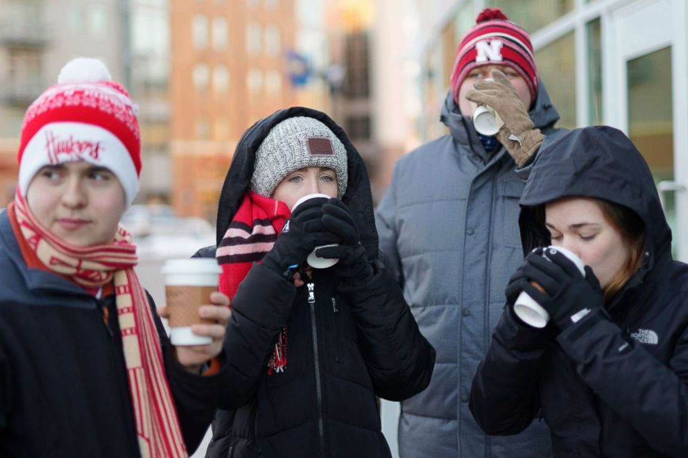 PHOTO: University of Nebraska students sip complementary hot chocolate as they wait in freezing temperatures to be admitted to Pinnacle Bank Arena for an NCAA college basketball game against Wisconsin, in Lincoln, Neb., Jan. 29, 2019.