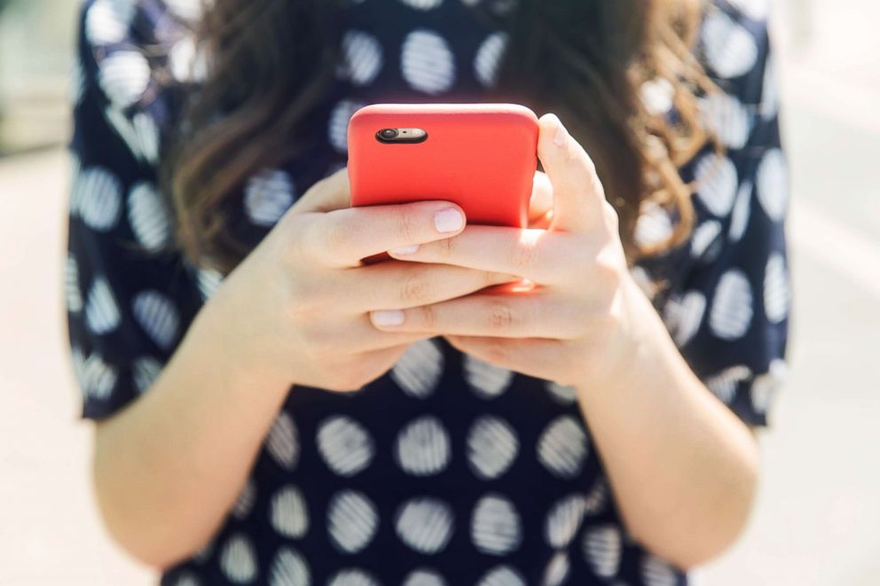 PHOTO: A woman holds a cell phone in this undated stock photo.