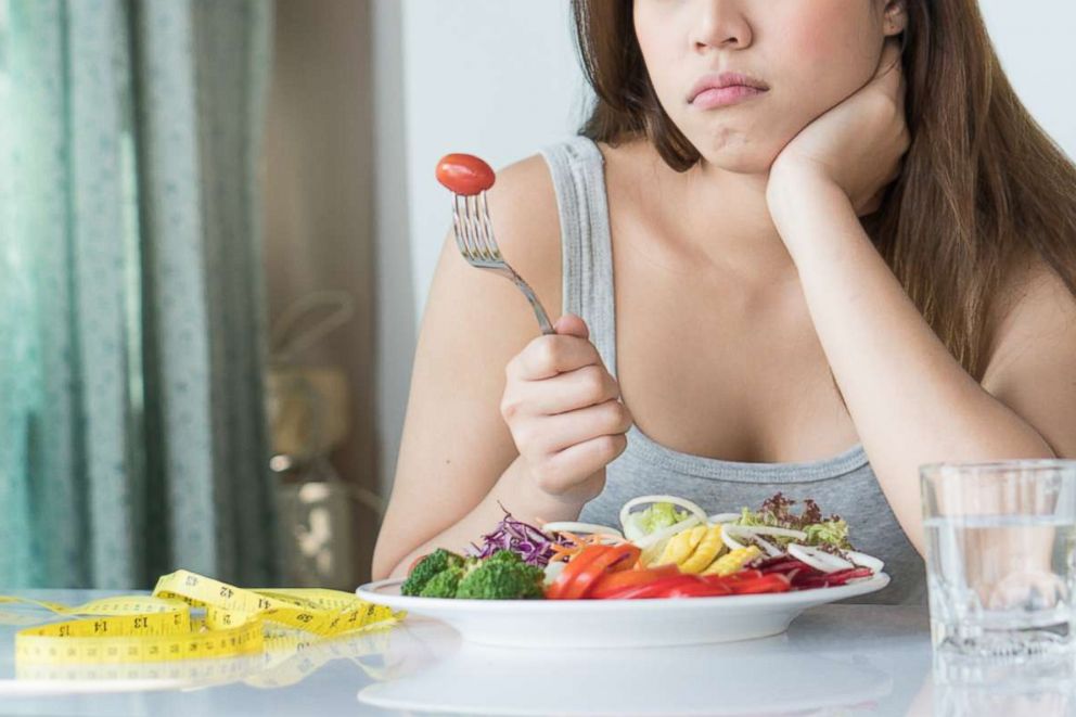 PHOTO: A women on a diet looks at a tomato on the fork in this undated stock photo.