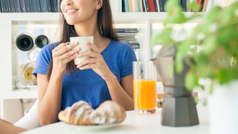 PHOTO: In this undated stock photo, a young woman having breakfast at home.