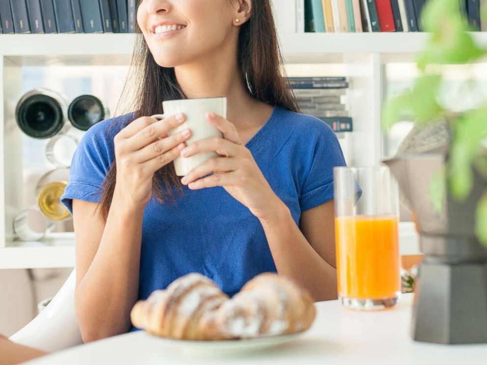 PHOTO: In this undated stock photo, a young woman having breakfast at home.