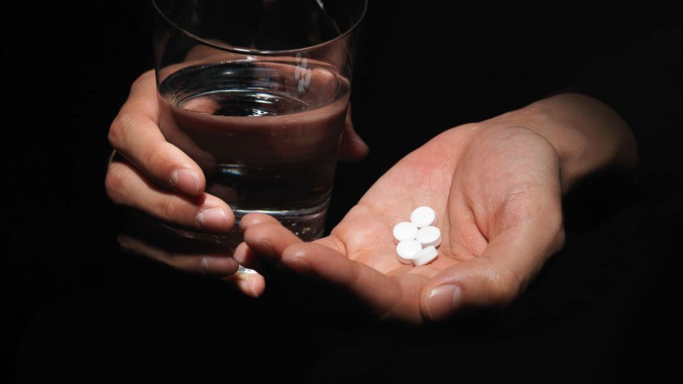In this stock photo, a young woman holds pills in her hand in this undated image.