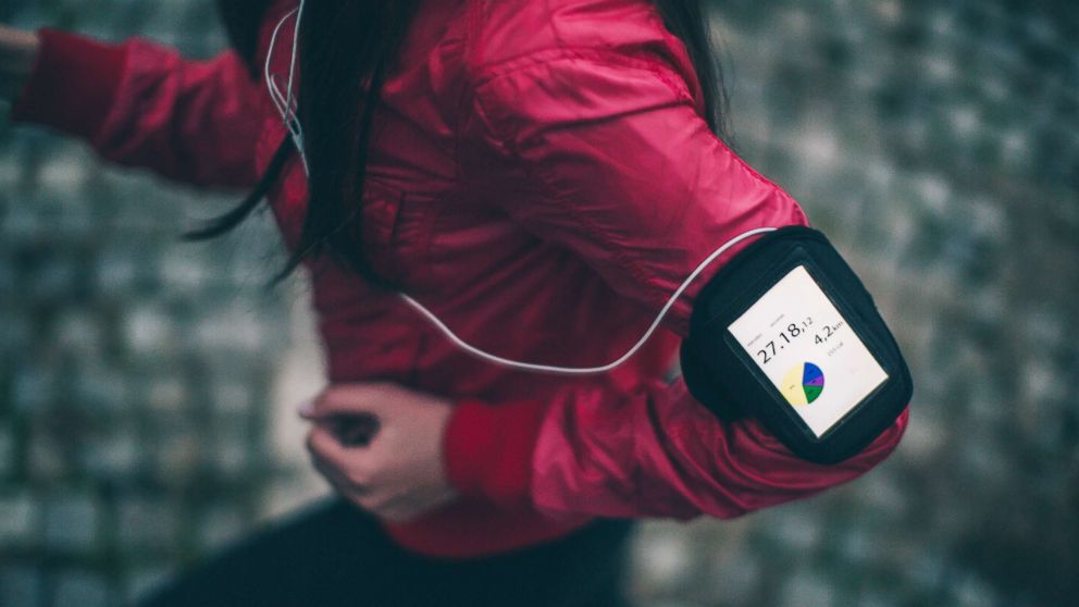 Woman exercising with a funning app on her smartphone.