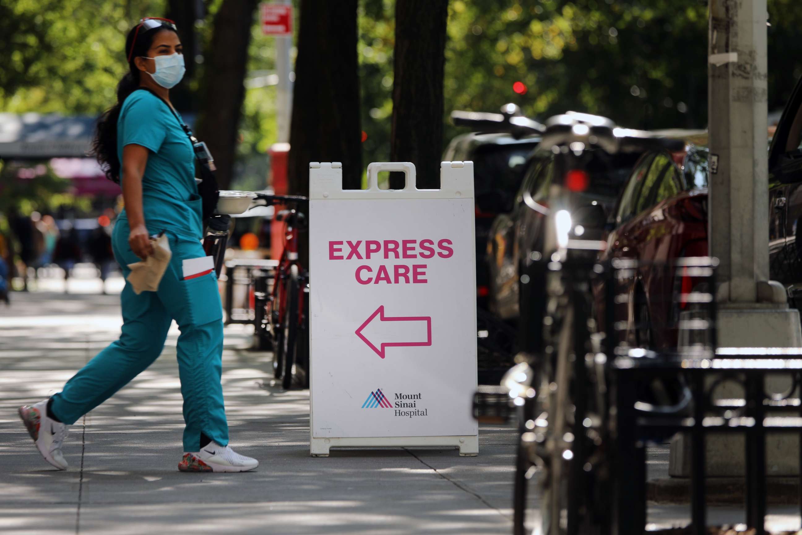 PHOTO: A medical worker walks past a sign that reads "Express Care."