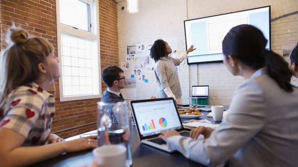 PHOTO: Businesswoman leading a meeting in a conference room.