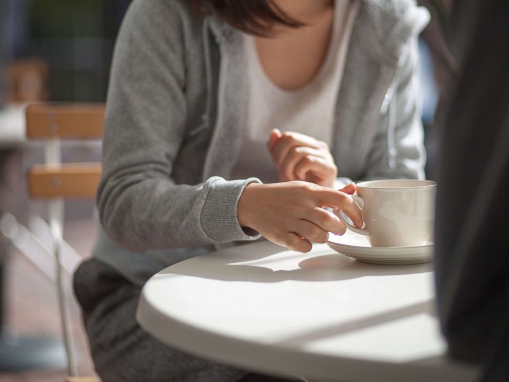 PHOTO: Woman having coffee.