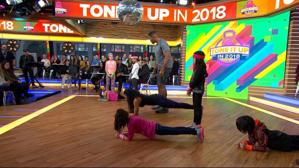 PHOTO: "GMA" anchor Michael Strahan and celebrity trainer Latreal Mitchell demonstrate a partner workout move, Jan. 12, 2018.