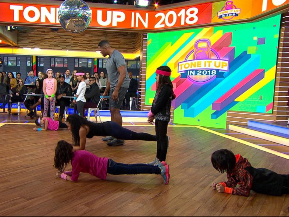 PHOTO: GMA anchor Michael Strahan and celebrity trainer Latreal Mitchell demonstrate a partner workout move, Jan. 12, 2018.
