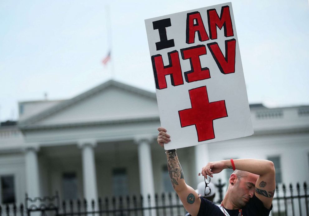 PHOTO: HIV+ patient Aaron Laxton of St. Louis, Missouri, holds up a sign in front of the White House after a march in Washington, July 24, 2012.