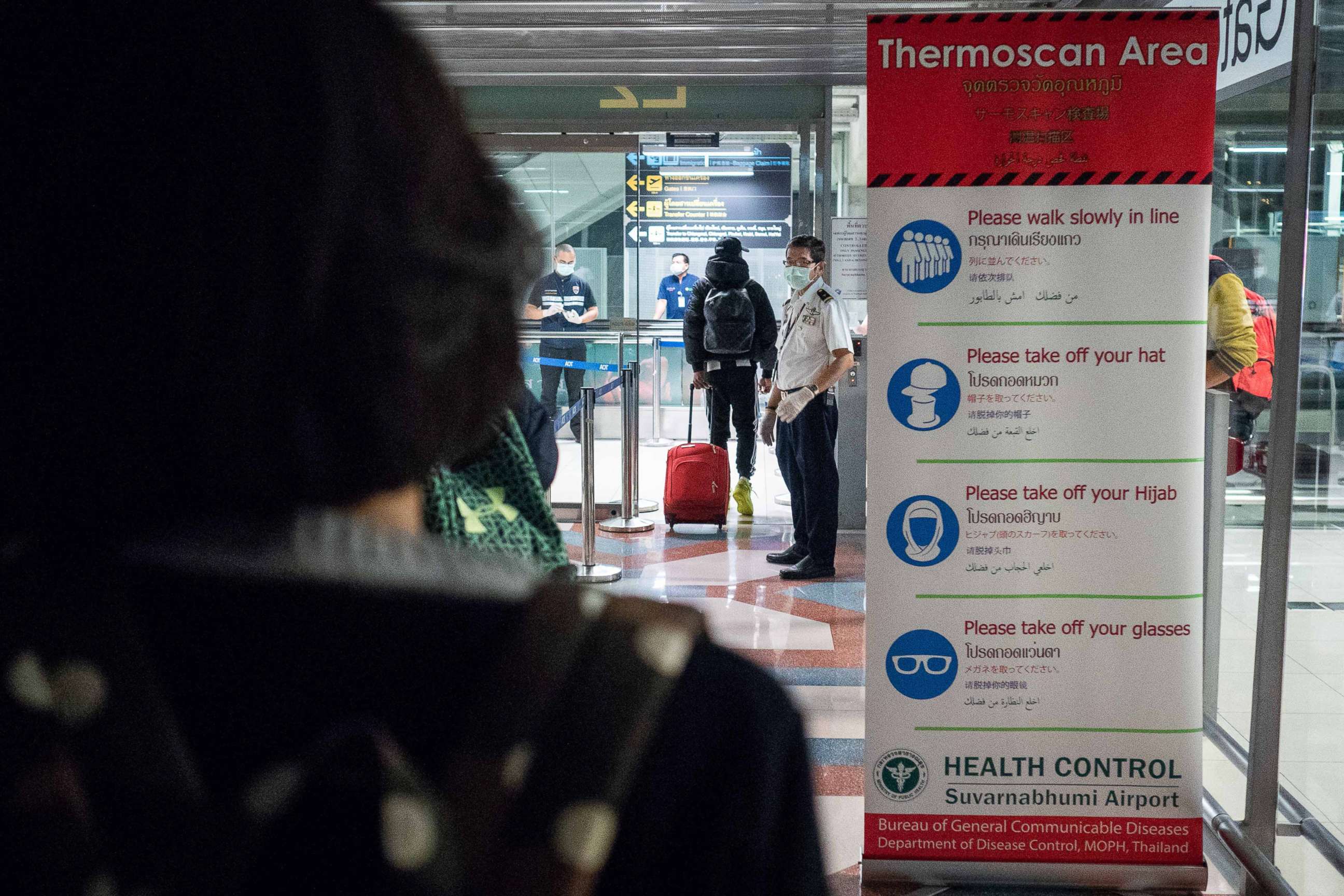 PHOTO: Public Health Officials run thermal scans on passengers arriving from Wuhan, China at Suvarnabumi Airport, Jan. 8, 2020, in Bangkok, Thailand.