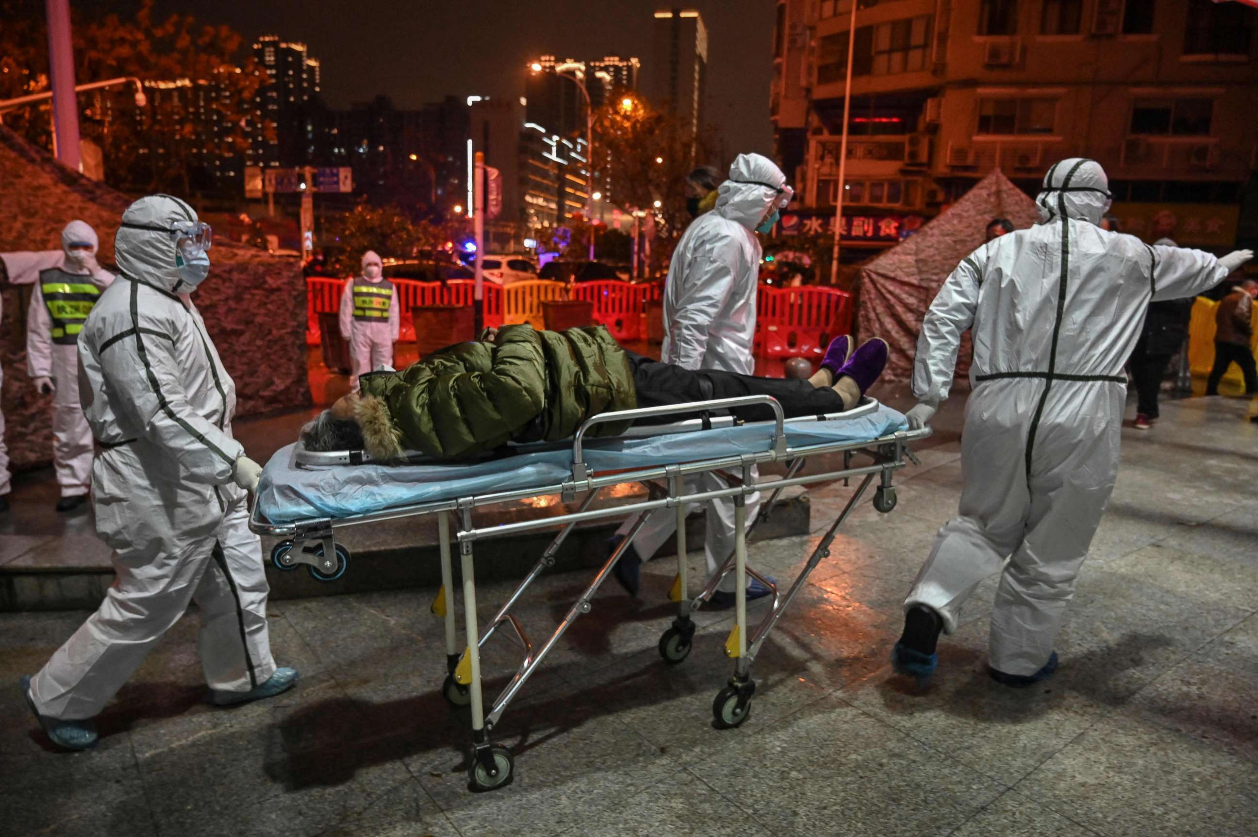 PHOTO: Medical staff members wearing protective clothing to help stop the spread of a deadly virus which began in the city, arrive with a patient at the Wuhan Red Cross Hospital in Wuhan, China, Jan. 25, 2020.