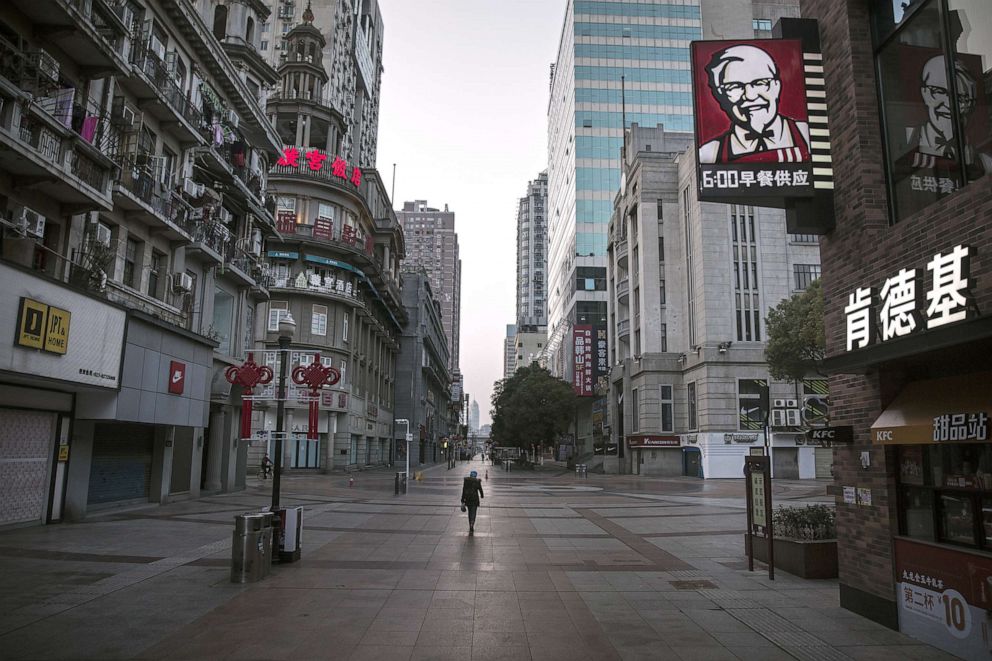 PHOTO: A resident wears a protective mask as she walk on an empty business street, Feb. 13, 2020, in Wuhan, China.