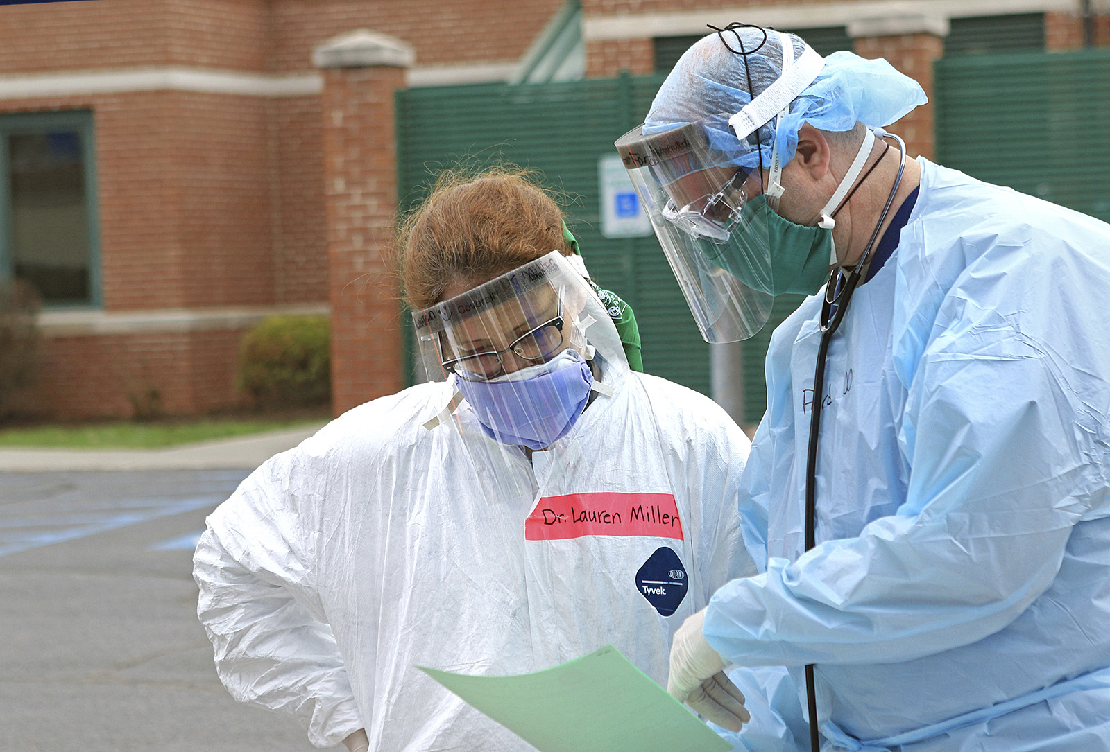PHOTO: Dr. Lauren Miller, left, and Dr. Micah Moore look over notes at a Mobile Health Unit for drive-thru coronavirus testing at Robert C. Byrd Clinic on the campus of the West Virginia School of Osteopathic Medicine in Lewisburg, W.Va., March 24, 2020.