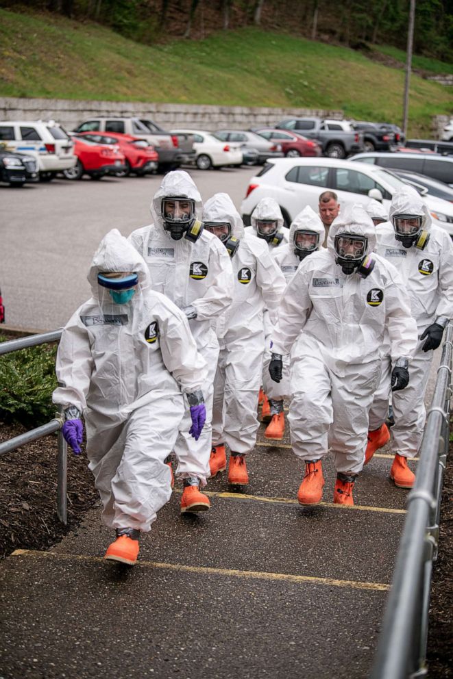 PHOTO: Members of the West Virginia National Guard's Task Force Chemical, Biological, Radiological and Nuclear (CBRN) Response Enterprise wear protective clothing at an Eastbrook Center nursing home in Charleston, West Virginia, April 6, 2020.