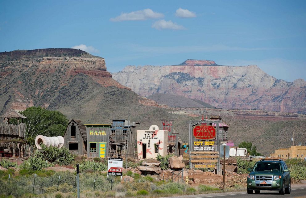 PHOTO: With Zion National Park in the background, a new for sale sign sits in front of Fort Zion tourist attraction on May 14, 2020 outside Springdale, Utah.