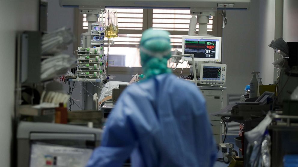 PHOTO: In this photo taken on March 16, 2020, a doctor watches a coronavirus patient under treatment in the intensive care unit of the Brescia hospital in Italy.