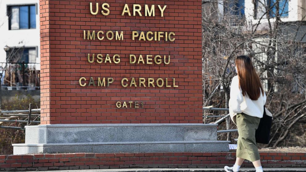 PHOTO: A woman walks past the main gate of U.S. Army Camp Carroll in Chilgok, about 18 miles north of Daegu, South Korea, on Feb. 26, 2020.