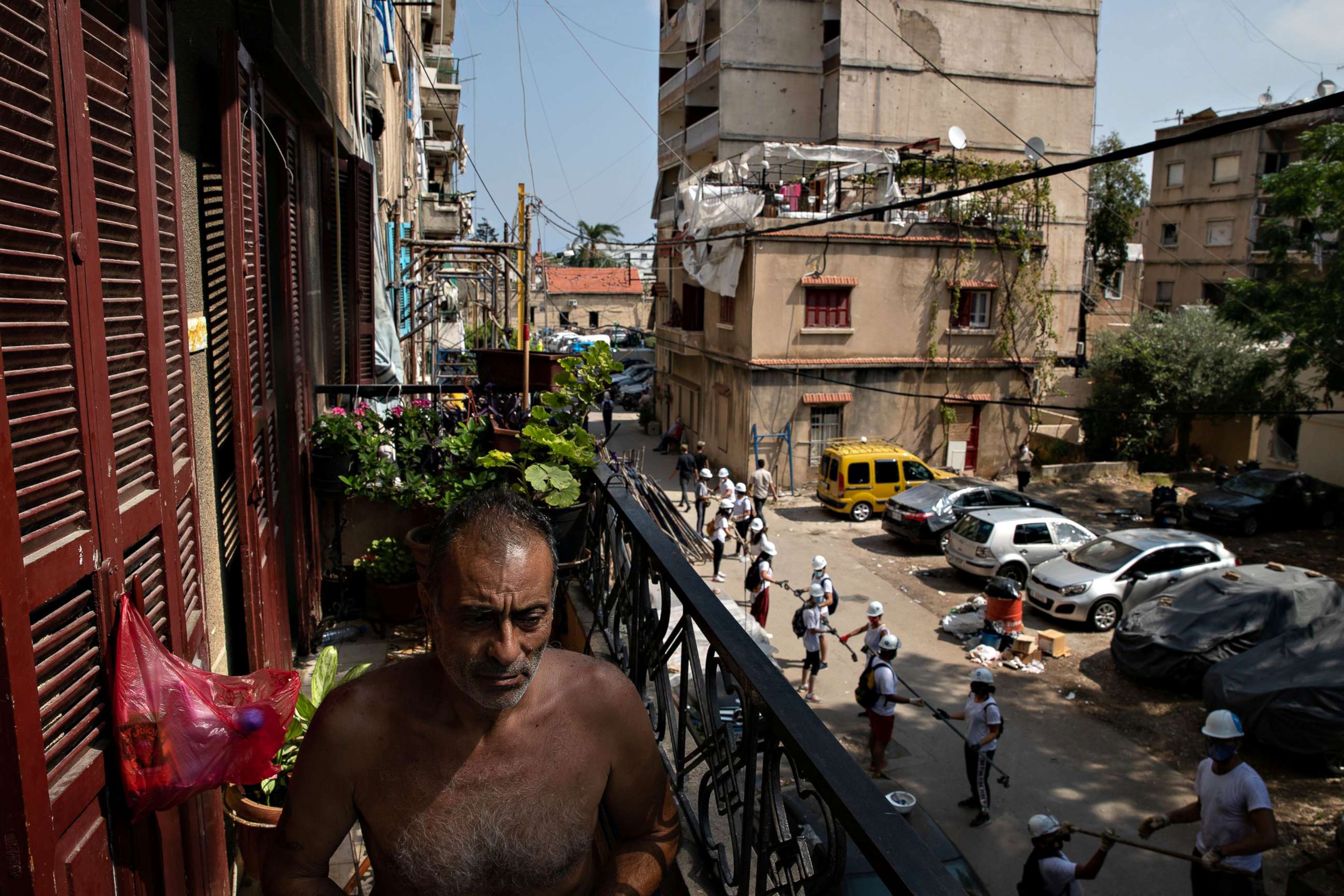 PHOTO: Abdou Batrouni sits on the balcony of his home that was damaged by the port explosion in the Karantina neighborhood of Beirut, Aug. 13, 2020.