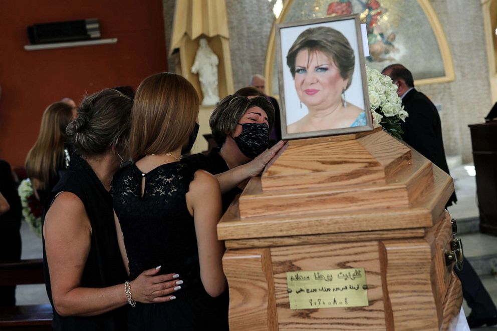 PHOTO: A woman grieves alongside the coffin of Claudette Halabi, who was killed by the Beirut Port explosion, during her funeral procession in Beirut, Aug. 11, 2020.