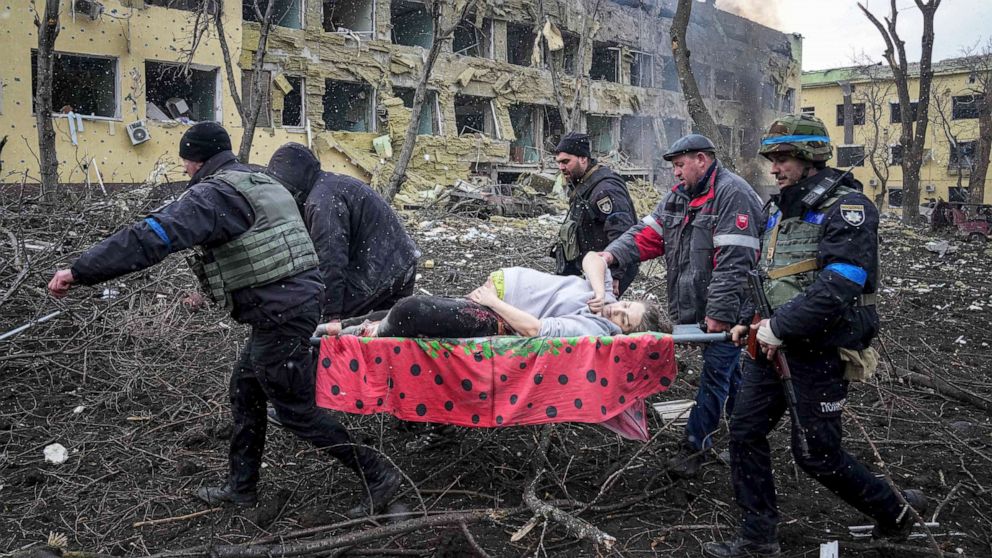 PHOTO: Ukrainian emergency employees and volunteers carry an injured pregnant woman from a maternity hospital damaged by shelling in Mariupol, Ukraine, March 9, 2022. The woman and her child died at another hospital. 