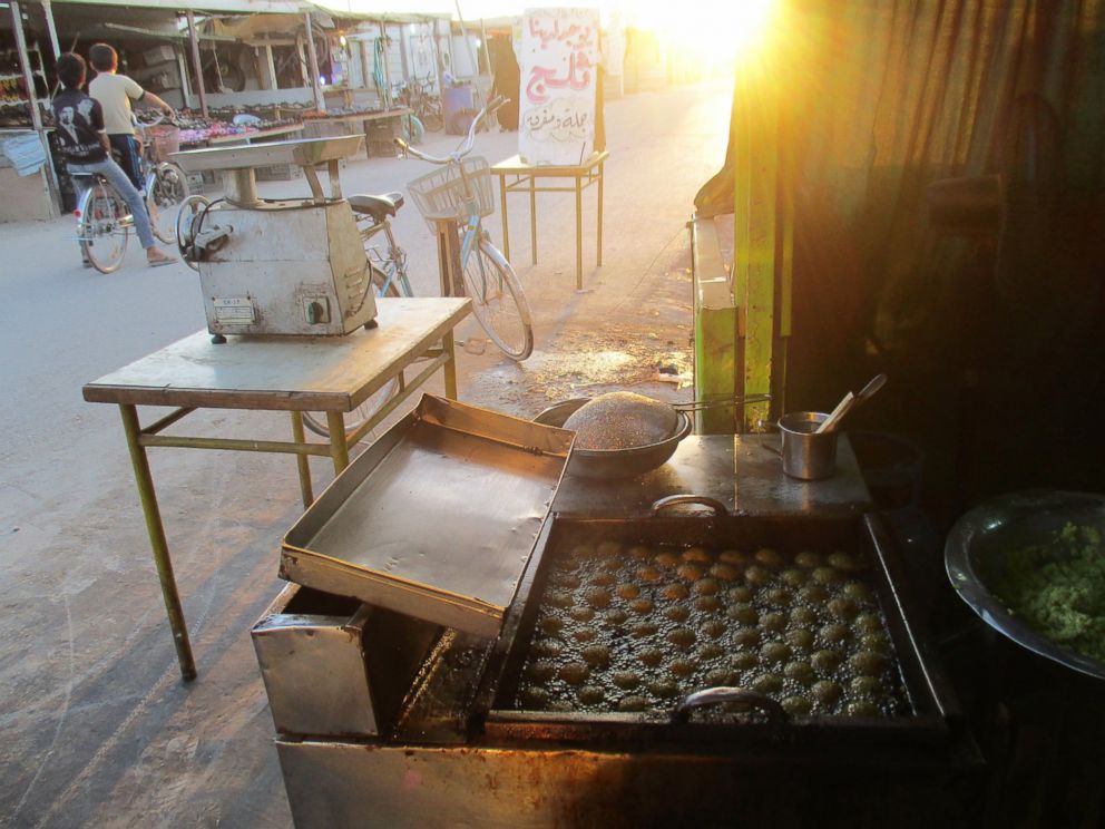 PHOTO: The falafel fryer and the beauty of food with the rays of sunlight shown through the mosque minaret at dusk. It gives me hope for a better life someday.