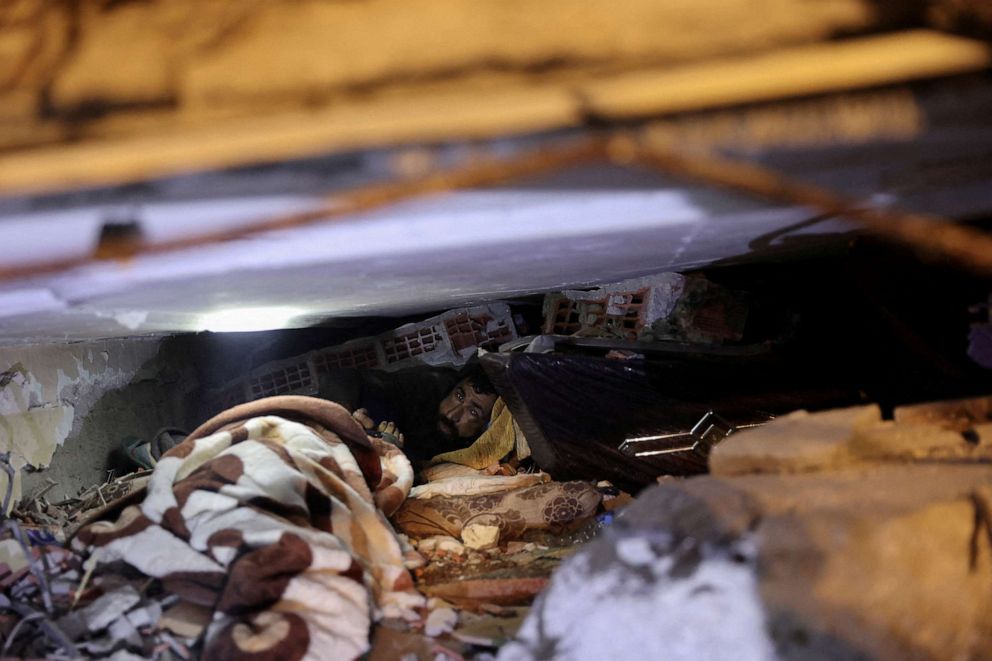 PHOTO:Abdulalim Muaini looks out from under rubble in Hatay, Turkey, Feb. 8, 2023.